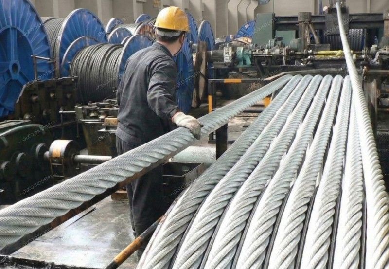 technicians inspecting steel cable strands