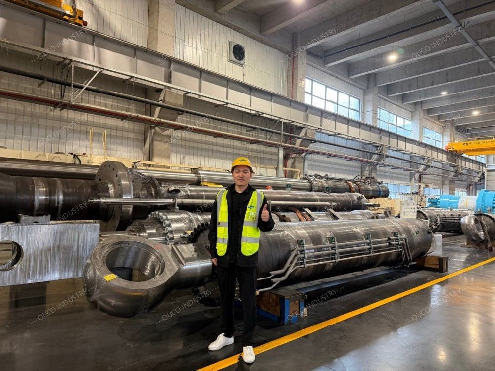 standing next to massive marine hydraulic cylinders