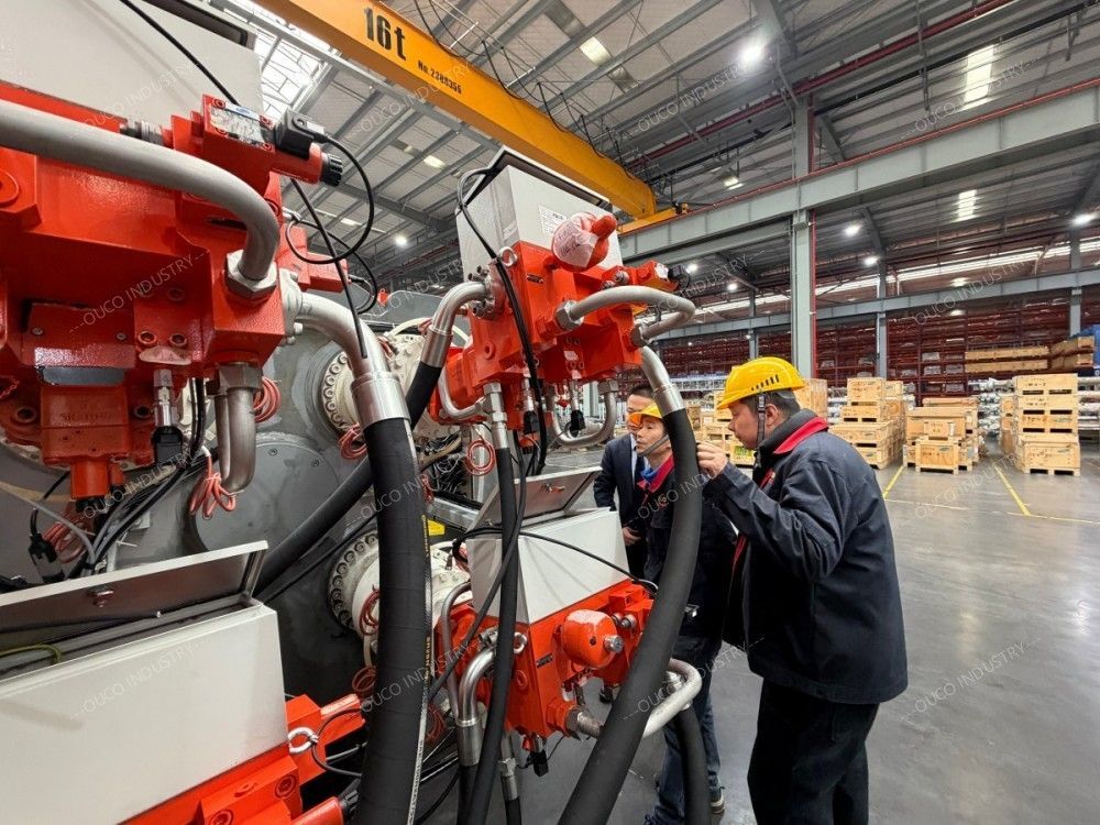 Engineers inspecting complex hydraulic equipment during a factory tour Engineers inspecting complex hydraulic equipment during a factory tour